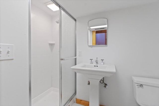 bathroom with toilet and walk in shower