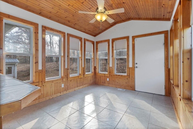 unfurnished sunroom with ceiling fan, lofted ceiling, and wood ceiling