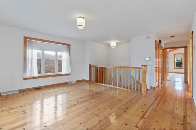 spare room featuring light wood-type flooring