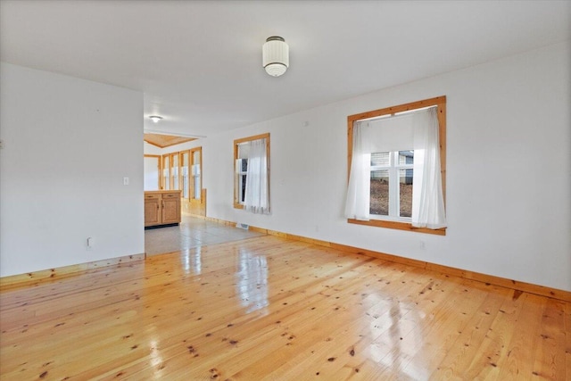 spare room featuring light hardwood / wood-style floors