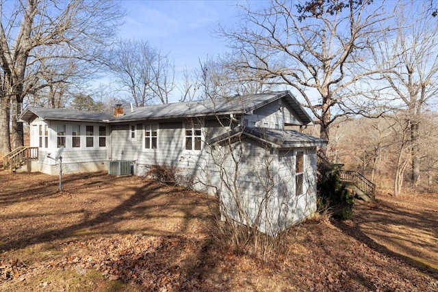 back of house featuring cooling unit