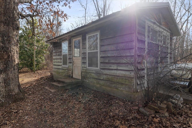 view of side of home featuring an outbuilding