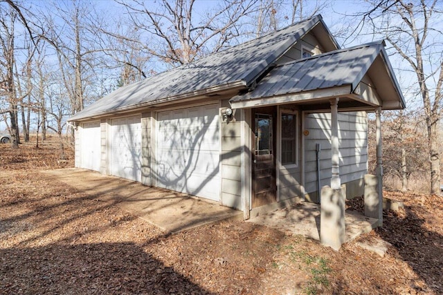 exterior space with a garage and an outdoor structure