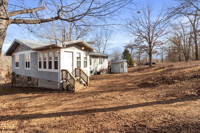 view of home's exterior featuring a storage unit