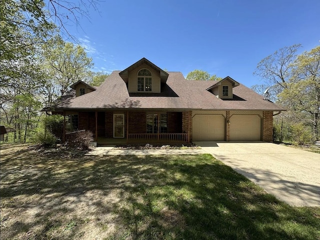 new england style home featuring brick siding, an attached garage, roof with shingles, covered porch, and driveway