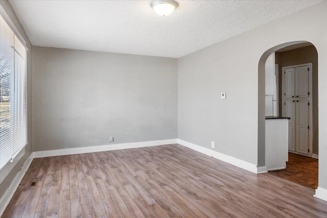 empty room featuring light hardwood / wood-style floors and a textured ceiling