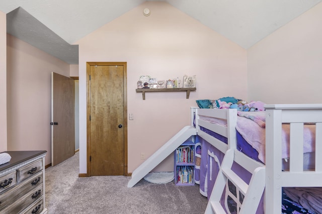 bedroom featuring vaulted ceiling and carpet flooring