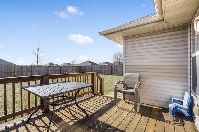 wooden deck featuring a lawn