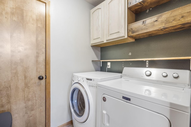 washroom featuring washer and clothes dryer and cabinets