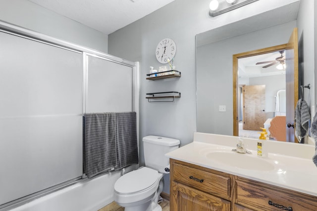 full bathroom featuring toilet, vanity, and bath / shower combo with glass door