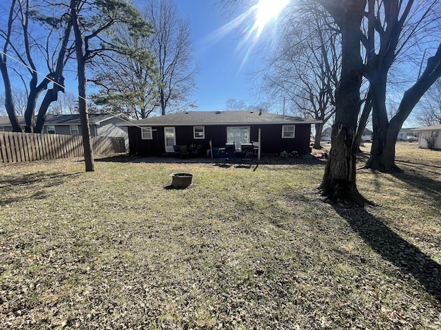 rear view of property featuring a yard