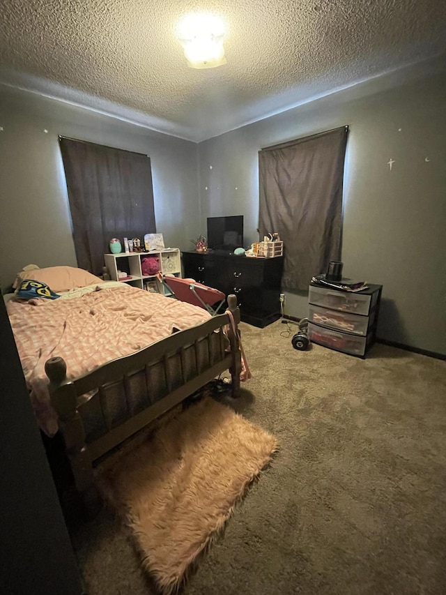 carpeted bedroom with a textured ceiling