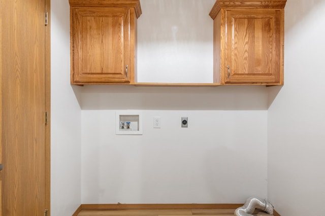 laundry area with hookup for a washing machine, electric dryer hookup, and cabinets