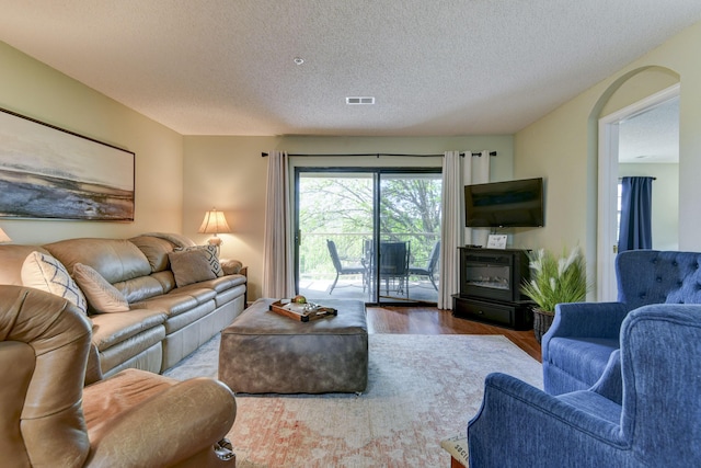 living room featuring hardwood / wood-style floors and a textured ceiling