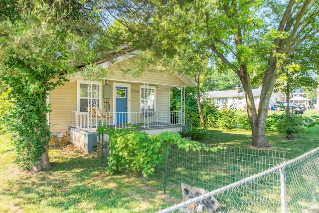 bungalow-style home with a front lawn and covered porch