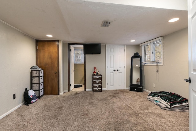 workout area featuring carpet and a textured ceiling