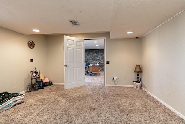 carpeted spare room with a textured ceiling