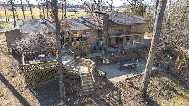 back of house with a balcony, a deck, and a patio area