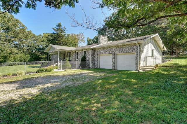 ranch-style home with a garage and a front lawn