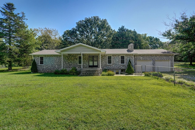 ranch-style home featuring a garage and a front lawn