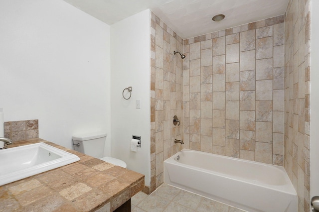 full bathroom with tile patterned flooring, sink, tiled shower / bath, and toilet