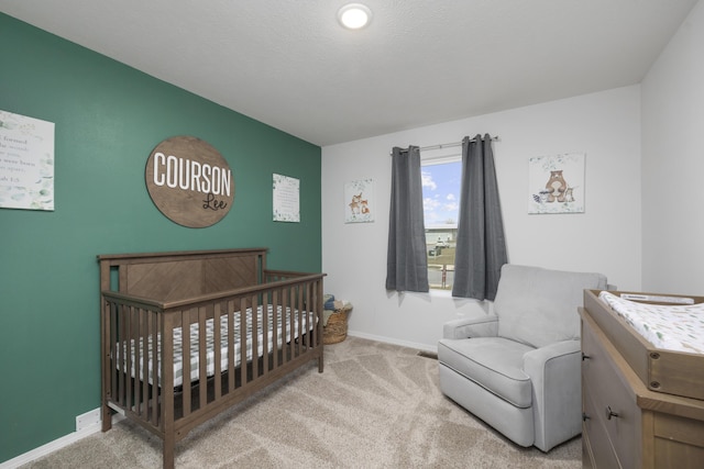 carpeted bedroom featuring a crib