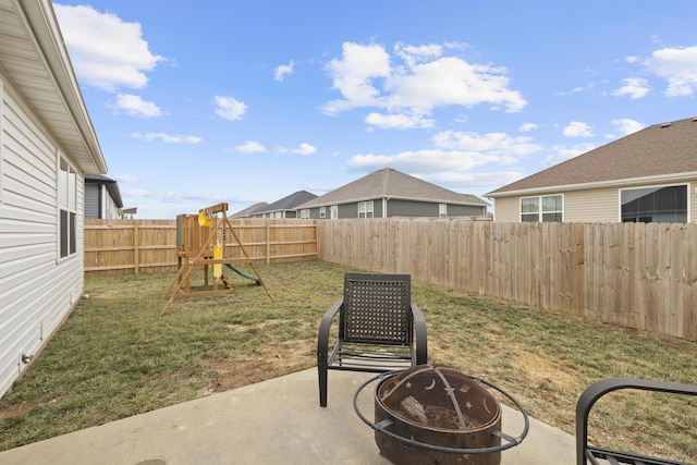 view of patio featuring a playground and a fire pit