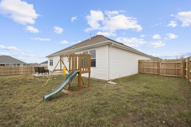 back of house with a yard, a playground, and a patio