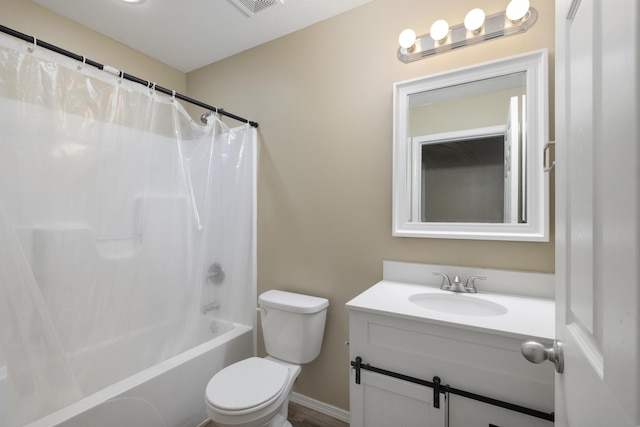 full bathroom with vanity, shower / bath combo, and toilet