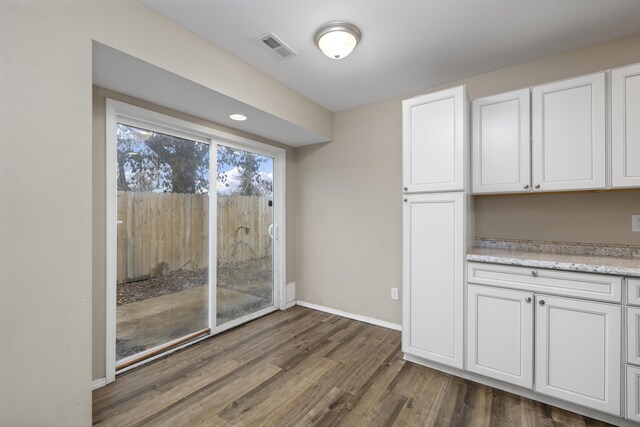 unfurnished dining area featuring dark hardwood / wood-style floors