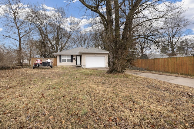 view of front of property with a garage and a front yard