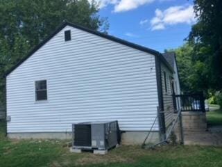 view of side of home featuring central AC unit