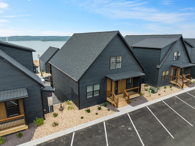 view of front of home with a water view and covered porch