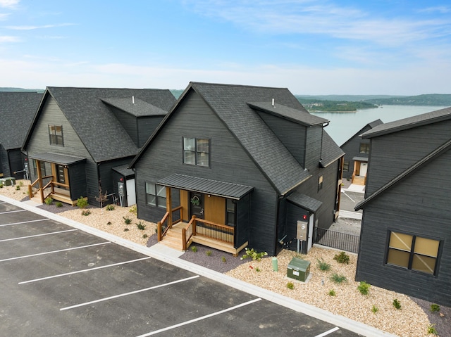 view of front facade featuring a water view and covered porch