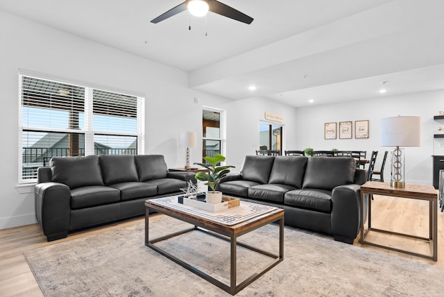 living room featuring ceiling fan and light wood-type flooring