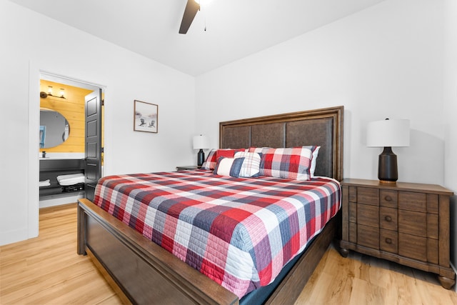 bedroom featuring ceiling fan, light hardwood / wood-style floors, and ensuite bath