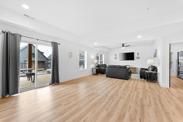 living room featuring ceiling fan and light wood-type flooring