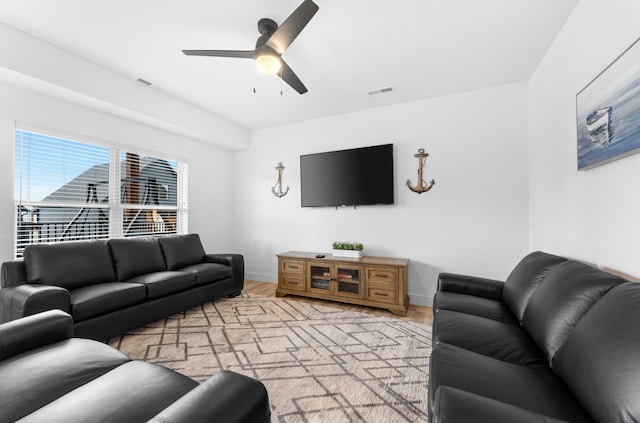 living room with ceiling fan and light hardwood / wood-style flooring