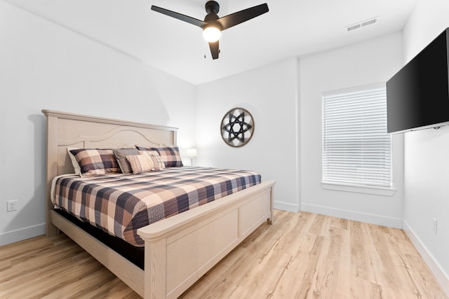 bedroom with light hardwood / wood-style floors and ceiling fan