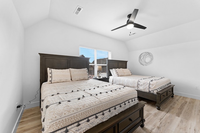 bedroom with vaulted ceiling, light hardwood / wood-style floors, and ceiling fan