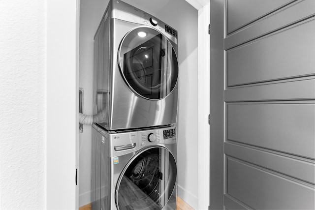 laundry room with stacked washer / drying machine