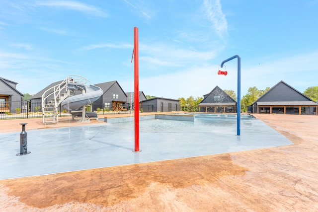 view of swimming pool featuring a gazebo and a water slide