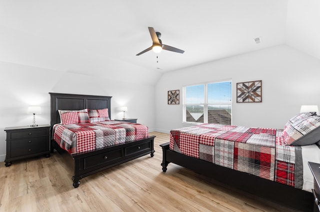 bedroom featuring lofted ceiling, light hardwood / wood-style floors, and ceiling fan