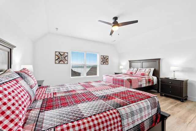 bedroom with lofted ceiling, light hardwood / wood-style floors, and ceiling fan