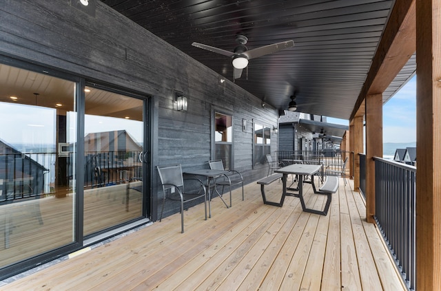 wooden terrace featuring ceiling fan and a water view