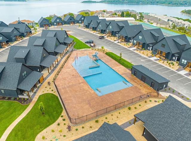 view of swimming pool featuring a water view