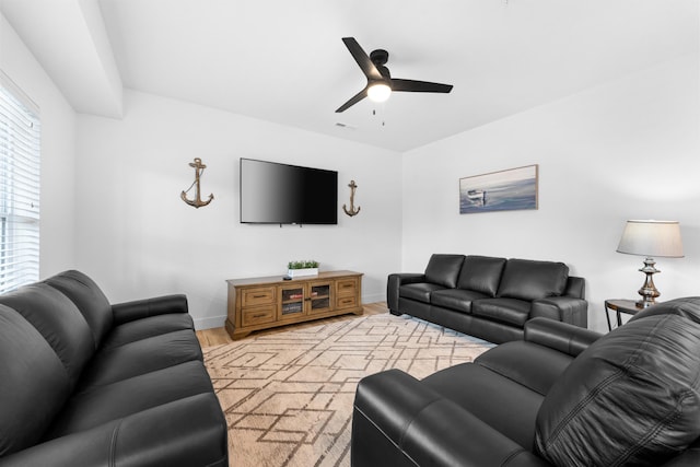 living room featuring light hardwood / wood-style flooring and ceiling fan