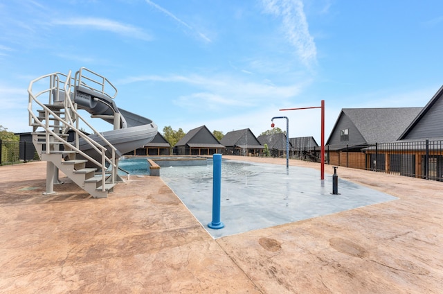 view of pool with a playground and a water slide