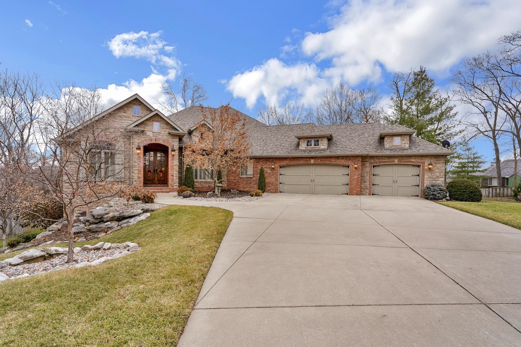 view of front of home with a garage and a front yard