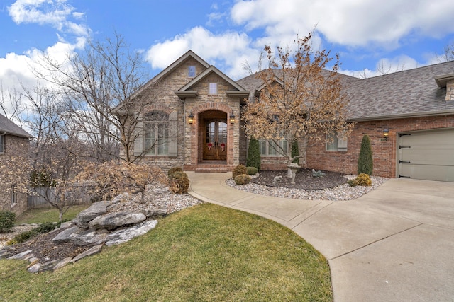 view of front of property featuring a garage and a front lawn